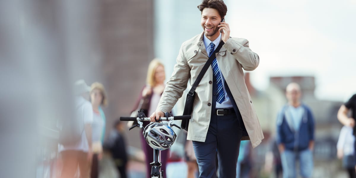 man walking outside with bicycle