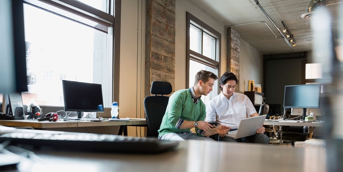 two business people looking at a laptop