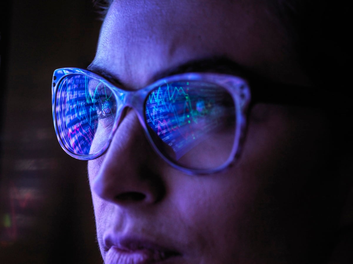 Face wearing glasses with screen reflected in them