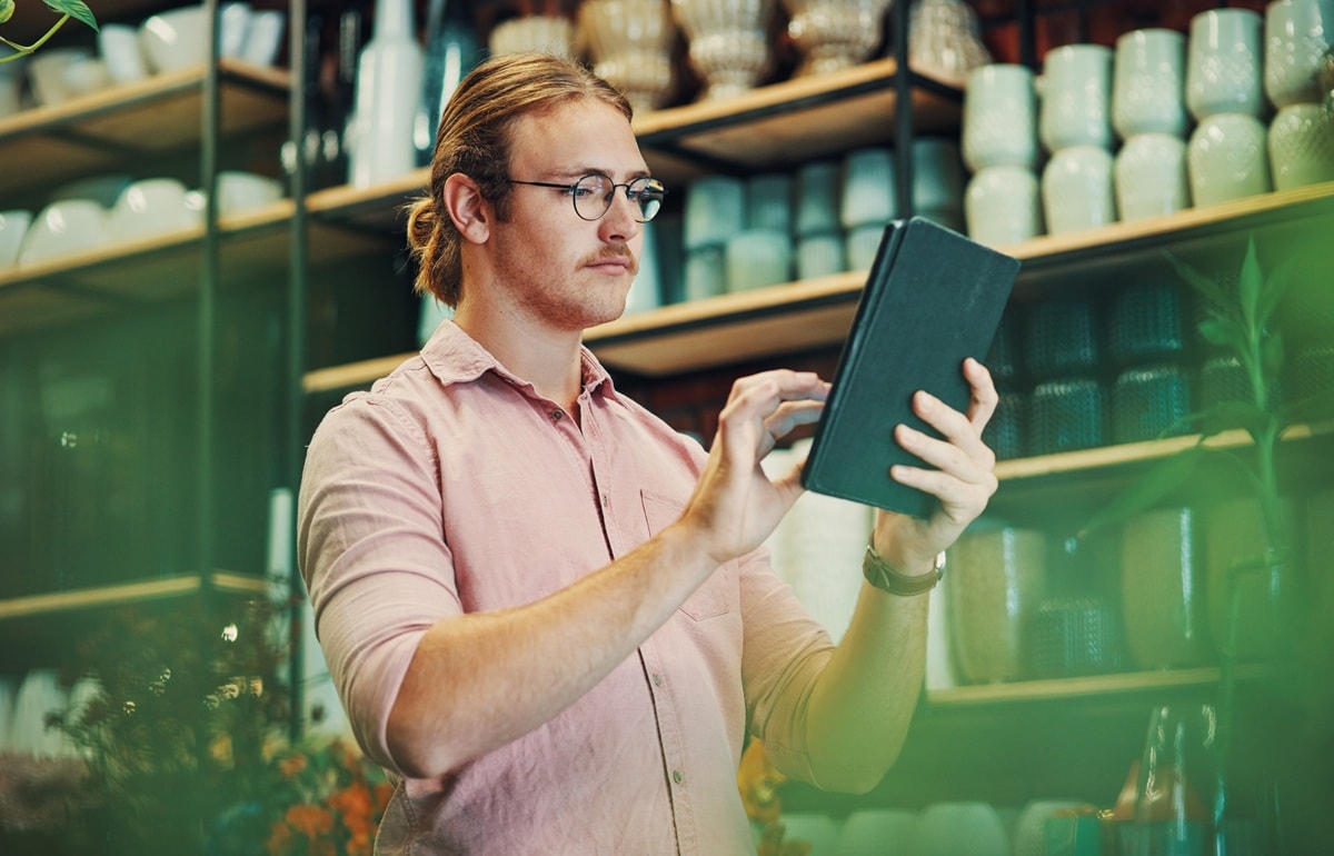 Man standing looking at ipad