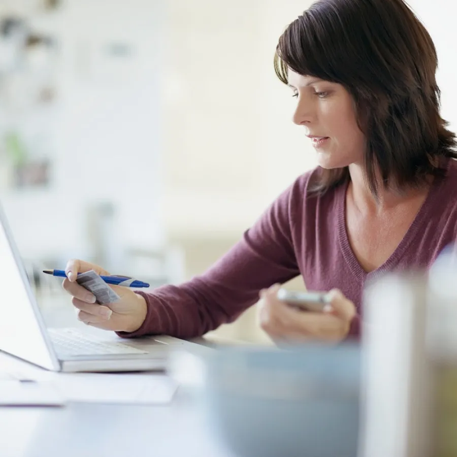 Lady putting credit card details into laptop